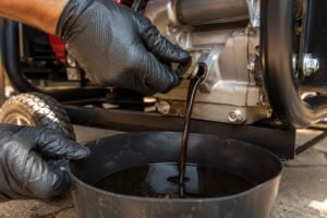 Changing the oil on a home generator by draining it into a pan