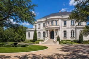 Neoclassical French-style mansion exterior with columns and a grand staircase